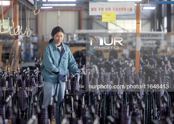 Workers rush to make Japanese-ordered products on the wheelchair production line of Zhongjin Medical Equipment Taizhou Co., Ltd. in Taizhou,...