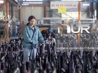 Workers rush to make Japanese-ordered products on the wheelchair production line of Zhongjin Medical Equipment Taizhou Co., Ltd. in Taizhou,...