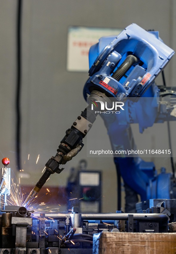 Workers rush to make Japanese-ordered products on the wheelchair production line of Zhongjin Medical Equipment Taizhou Co., Ltd. in Taizhou,...