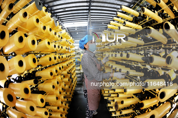 A worker works on the production line of a woven bag company in Lianyungang, China, on October 8, 2024. 