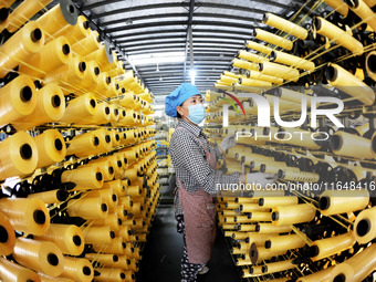 A worker works on the production line of a woven bag company in Lianyungang, China, on October 8, 2024. (