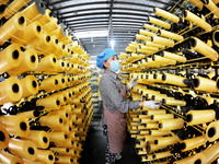 A worker works on the production line of a woven bag company in Lianyungang, China, on October 8, 2024. (