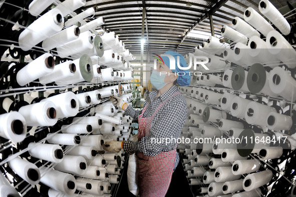 A worker works on the production line of a woven bag company in Lianyungang, China, on October 8, 2024. 