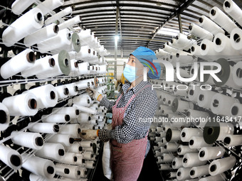 A worker works on the production line of a woven bag company in Lianyungang, China, on October 8, 2024. (