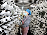 A worker works on the production line of a woven bag company in Lianyungang, China, on October 8, 2024. (