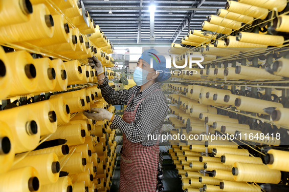 A worker works on the production line of a woven bag company in Lianyungang, China, on October 8, 2024. 