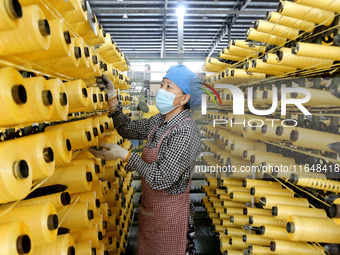 A worker works on the production line of a woven bag company in Lianyungang, China, on October 8, 2024. (