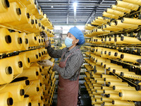 A worker works on the production line of a woven bag company in Lianyungang, China, on October 8, 2024. (