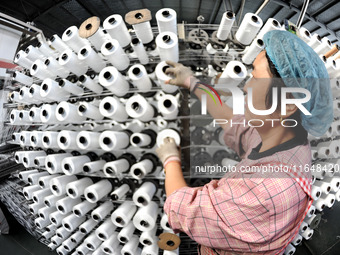 A worker works on the production line of a woven bag company in Lianyungang, China, on October 8, 2024. (