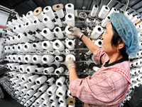 A worker works on the production line of a woven bag company in Lianyungang, China, on October 8, 2024. (