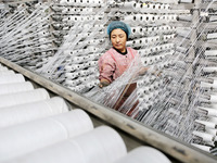 A worker works on the production line of a woven bag company in Lianyungang, China, on October 8, 2024. (