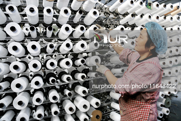 A worker works on the production line of a woven bag company in Lianyungang, China, on October 8, 2024. 