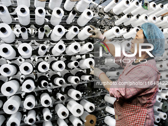 A worker works on the production line of a woven bag company in Lianyungang, China, on October 8, 2024. (