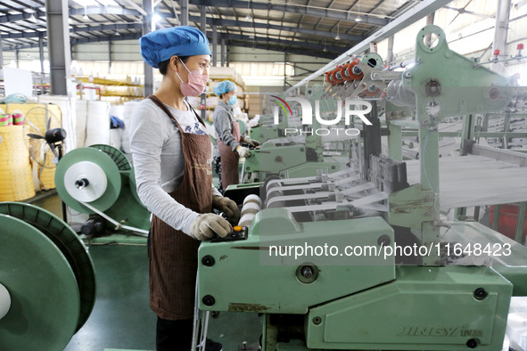 A worker works on the production line of a woven bag company in Lianyungang, China, on October 8, 2024. 