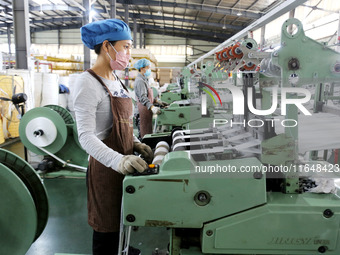 A worker works on the production line of a woven bag company in Lianyungang, China, on October 8, 2024. (