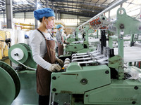 A worker works on the production line of a woven bag company in Lianyungang, China, on October 8, 2024. (