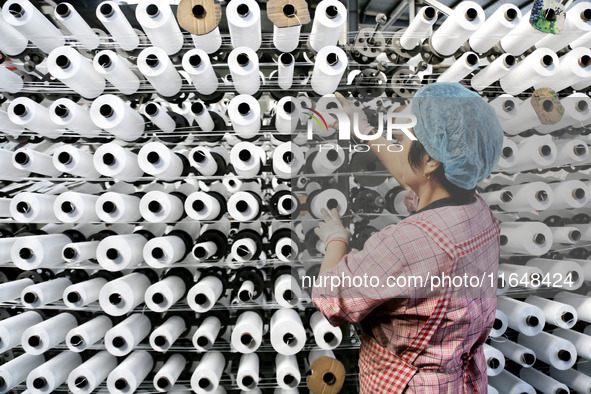 A worker works on the production line of a woven bag company in Lianyungang, China, on October 8, 2024. 