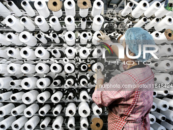 A worker works on the production line of a woven bag company in Lianyungang, China, on October 8, 2024. (