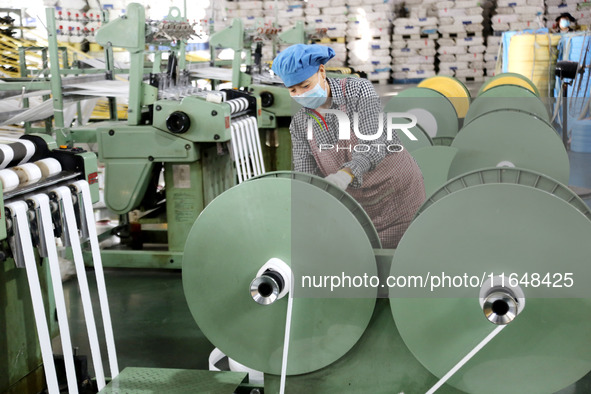 A worker works on the production line of a woven bag company in Lianyungang, China, on October 8, 2024. 