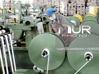 A worker works on the production line of a woven bag company in Lianyungang, China, on October 8, 2024. (