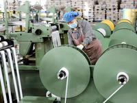 A worker works on the production line of a woven bag company in Lianyungang, China, on October 8, 2024. (