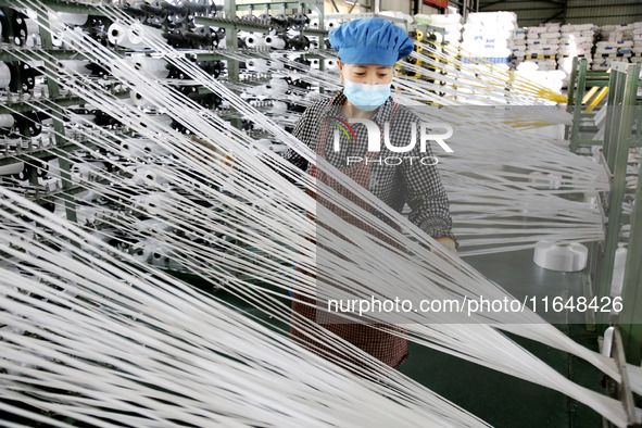 A worker works on the production line of a woven bag company in Lianyungang, China, on October 8, 2024. 