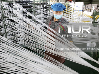 A worker works on the production line of a woven bag company in Lianyungang, China, on October 8, 2024. (