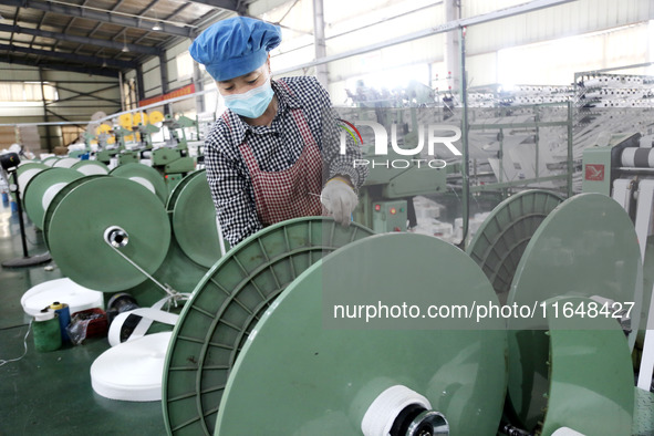 A worker works on the production line of a woven bag company in Lianyungang, China, on October 8, 2024. 