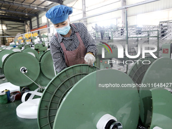 A worker works on the production line of a woven bag company in Lianyungang, China, on October 8, 2024. (