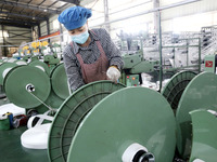 A worker works on the production line of a woven bag company in Lianyungang, China, on October 8, 2024. (