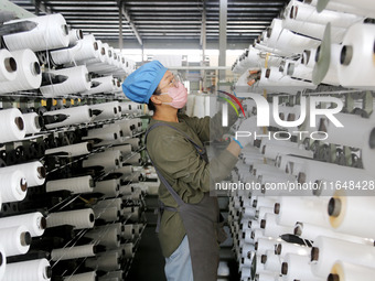 A worker works on the production line of a woven bag company in Lianyungang, China, on October 8, 2024. (