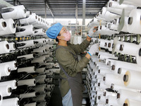 A worker works on the production line of a woven bag company in Lianyungang, China, on October 8, 2024. (