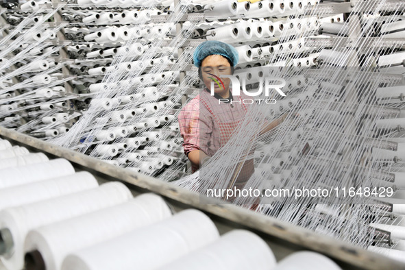 A worker works on the production line of a woven bag company in Lianyungang, China, on October 8, 2024. 