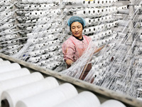 A worker works on the production line of a woven bag company in Lianyungang, China, on October 8, 2024. (