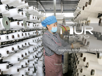 A worker works on the production line of a woven bag company in Lianyungang, China, on October 8, 2024. (