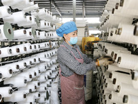 A worker works on the production line of a woven bag company in Lianyungang, China, on October 8, 2024. (