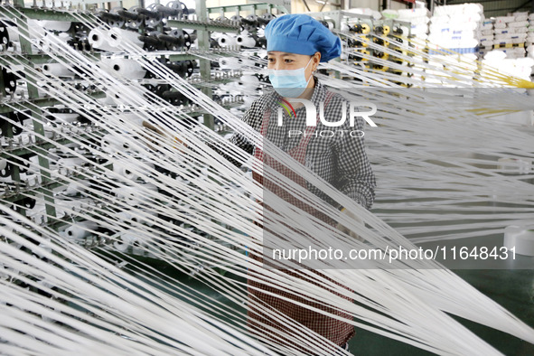 A worker works on the production line of a woven bag company in Lianyungang, China, on October 8, 2024. 