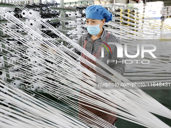 A worker works on the production line of a woven bag company in Lianyungang, China, on October 8, 2024. (