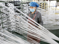 A worker works on the production line of a woven bag company in Lianyungang, China, on October 8, 2024. (