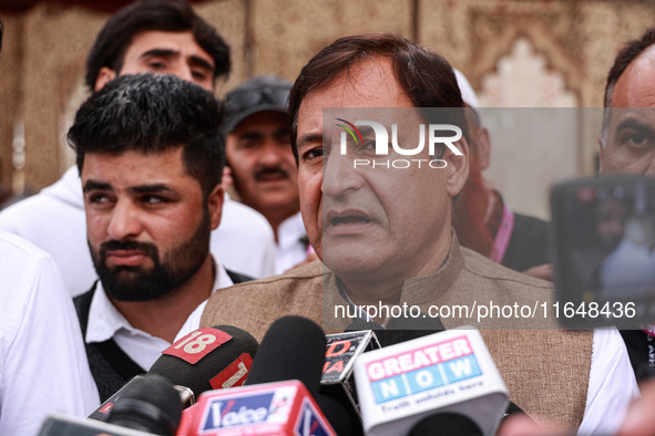 Javid Ahmad Dar, the National Conference Candidate for the Rafiabad Assembly Constituency, speaks to the media during election results in Ba...