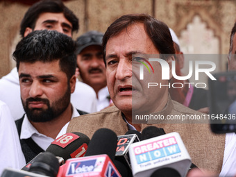 Javid Ahmad Dar, the National Conference Candidate for the Rafiabad Assembly Constituency, speaks to the media during election results in Ba...