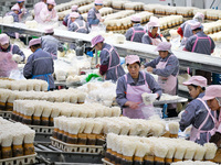 Workers pack golden mushrooms in a production workshop of Jiangsu Hualu Biotechnology Co LTD in Siyang National Modern Agriculture Industria...