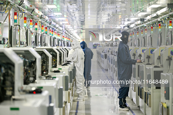 A worker works on an electronic component production line at Jiangsu Baopulai Semiconductor Co LTD in the Siyang Economic Development Zone i...