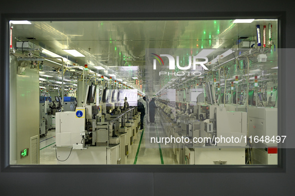 A worker works on an electronic component production line at Jiangsu Baopulai Semiconductor Co LTD in the Siyang Economic Development Zone i...