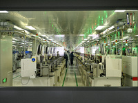 A worker works on an electronic component production line at Jiangsu Baopulai Semiconductor Co LTD in the Siyang Economic Development Zone i...