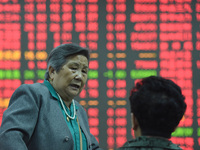 A customer pays attention to the stock market at a stock exchange in Hangzhou, China, on October 8, 2024. (