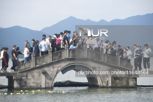 Crowds of people gather at West Lake during the National Day holiday in Hangzhou, China, on October 2, 2024. On October 8, 2024, according t...