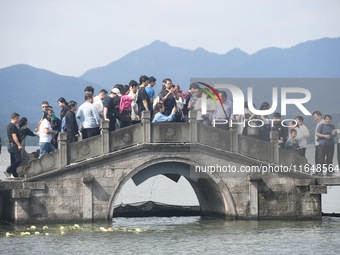 Crowds of people gather at West Lake during the National Day holiday in Hangzhou, China, on October 2, 2024. On October 8, 2024, according t...