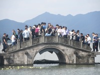 Crowds of people gather at West Lake during the National Day holiday in Hangzhou, China, on October 2, 2024. On October 8, 2024, according t...