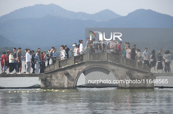 Crowds of people gather at West Lake during the National Day holiday in Hangzhou, China, on October 2, 2024. On October 8, 2024, according t...